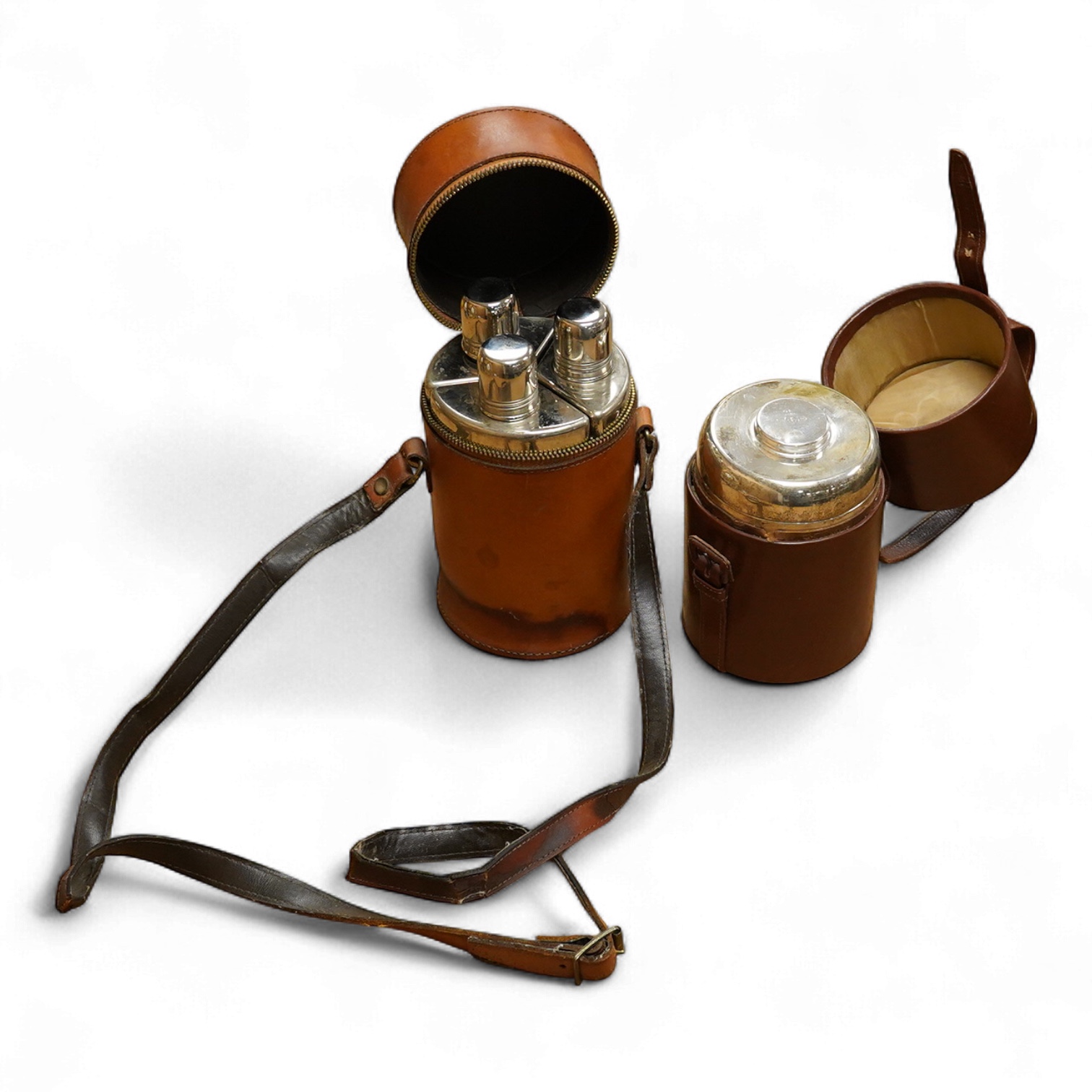 Two silver plate mounted flasks in cases to include a three sectioned example, largest 19cm high